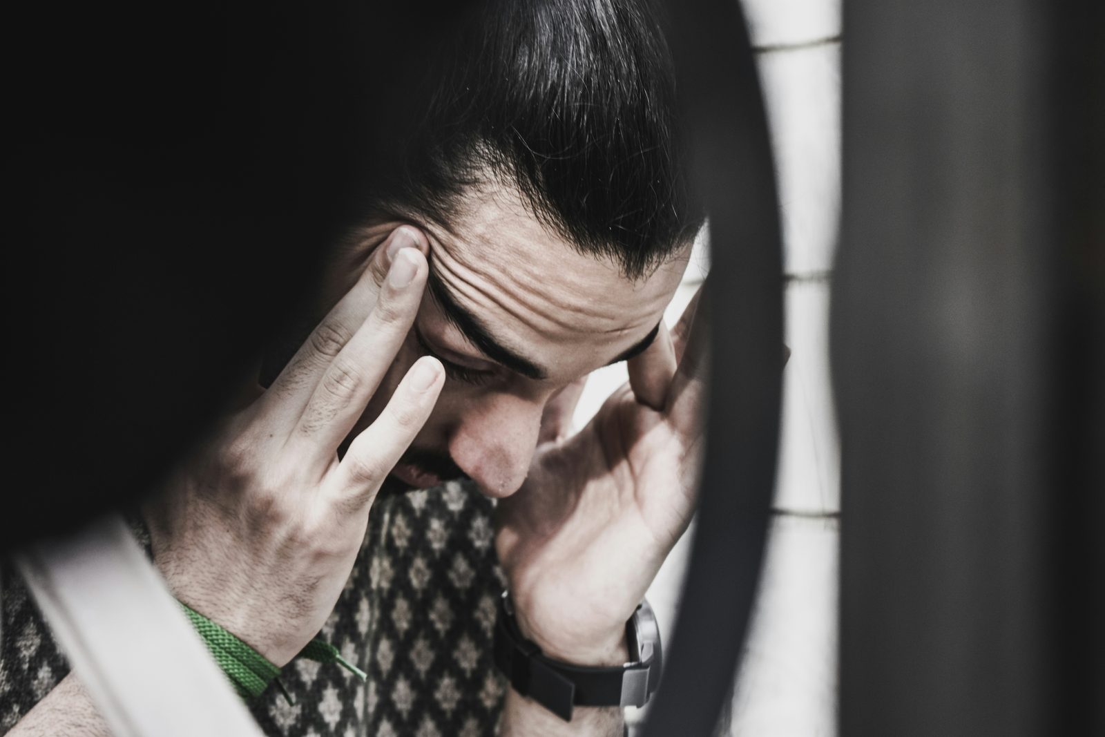 A tense, preoccupied man, representing anxiety and a mind that won't switch off, men's therapy in Ontario