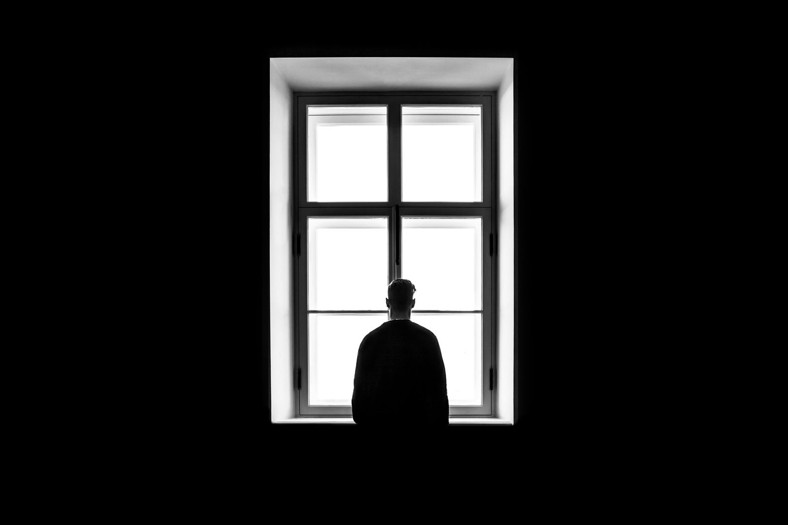 A man sitting apart on his own, quietly withdrawn